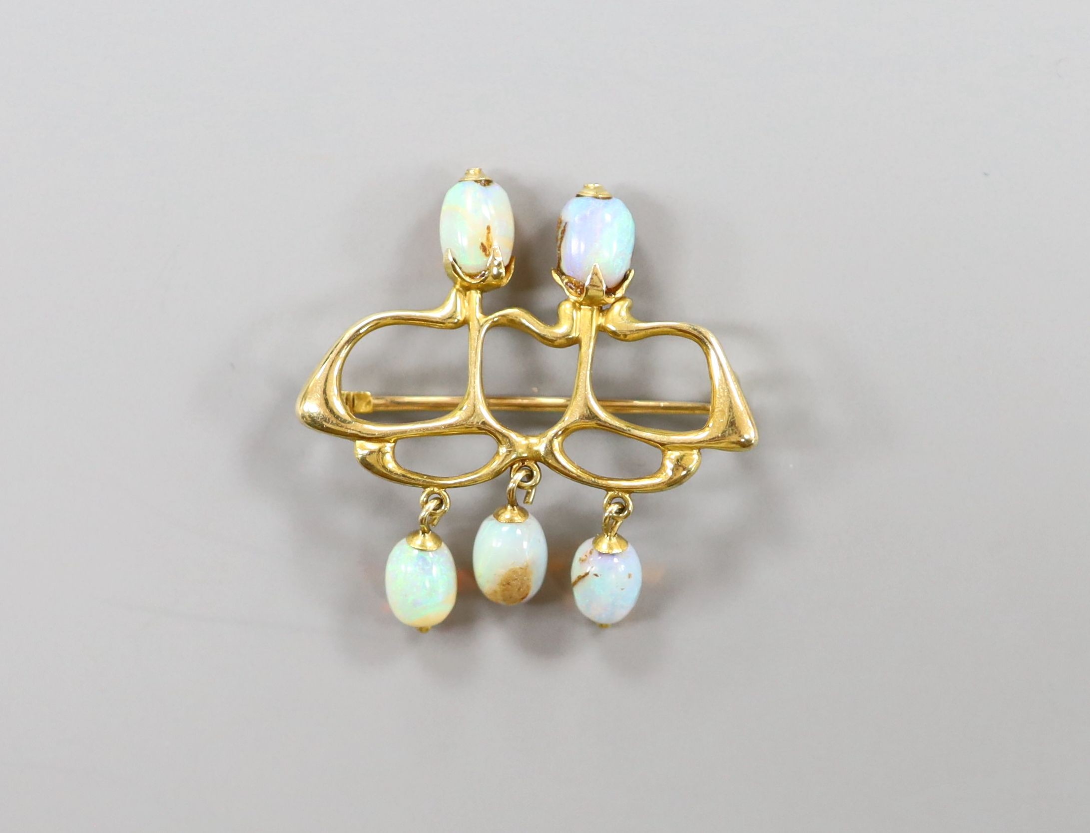 A stylish Art Nouveau yellow metal and five stone opal set brooch(a.f.), 31mm, gross weight 4.8 grams.